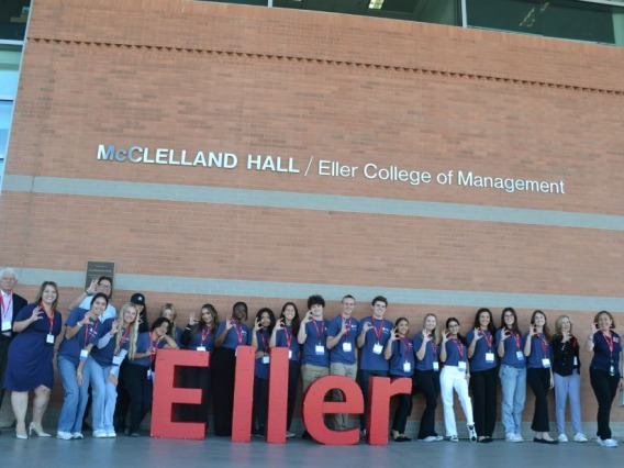Group picture of student volunteers in front of building